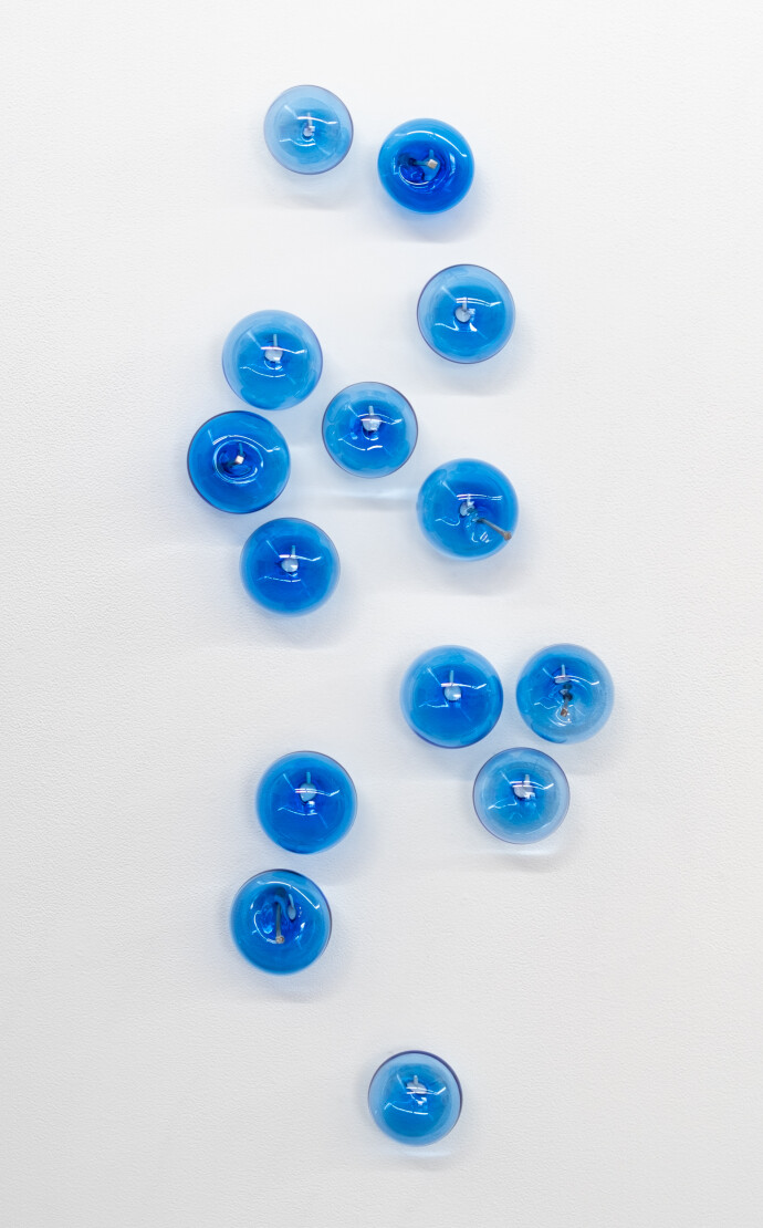 This contemporary cerulean-coloured glass wall sculpture was created by Cheryl Wilson Smith.