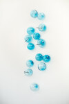 This contemporary wall sculpture features bubbles of blue glass. Image 3
