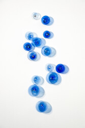 This contemporary cerulean colored glass wall sculpture was created by Cheryl Wilson Smith.