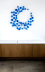 This contemporary glass wall sculpture features cerulean colored bubbles. Image 12