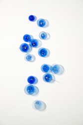 This contemporary cerulean colored glass wall sculpture was created by Cheryl Wilson Smith.