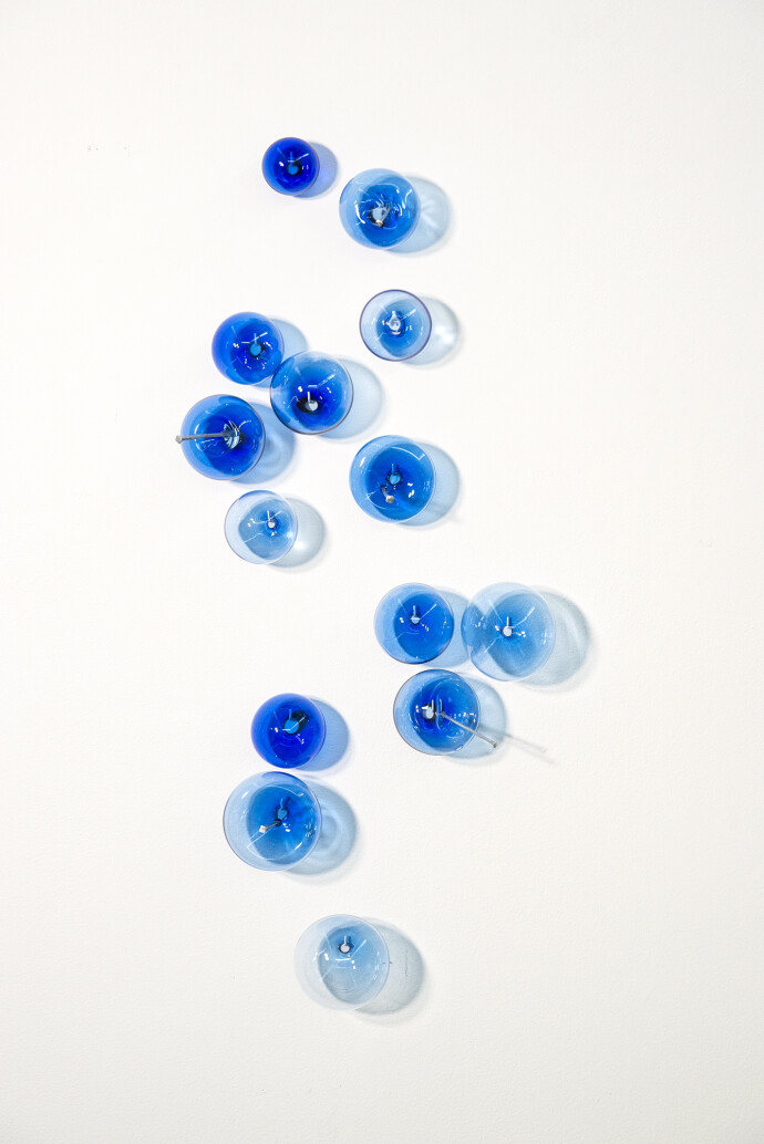 This contemporary cerulean colored glass wall sculpture was created by Cheryl Wilson Smith.