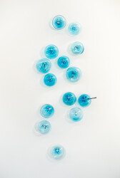 This contemporary wall sculpture features bubbles of blue glass.