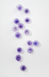 This contemporary, purple-colored, glass wall sculpture was created by Cheryl Wilson Smith.