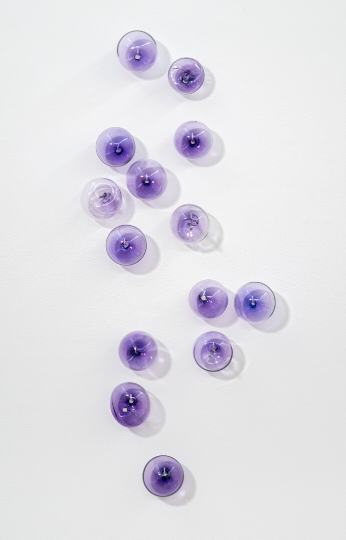 This contemporary, purple-colored, glass wall sculpture was created by Cheryl Wilson Smith.