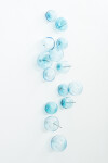 This contemporary wall sculpture features bubbles of blue glass. Image 12