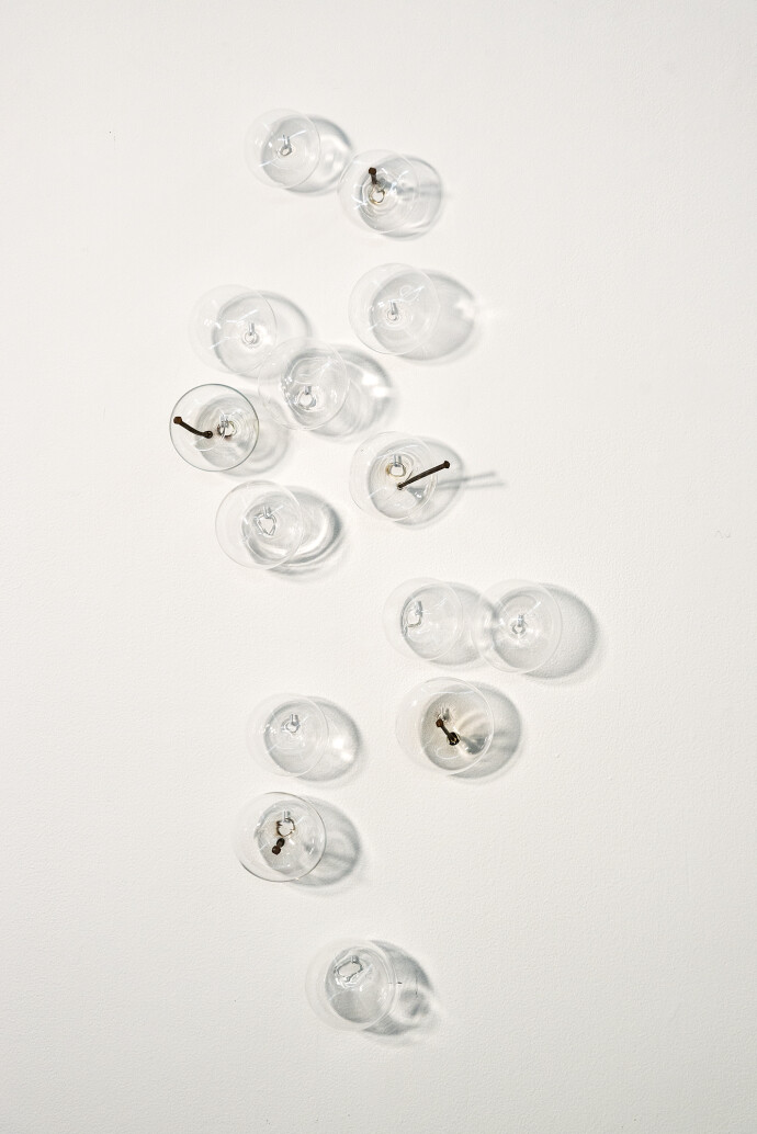 This contemporary wall sculpture features bubbles of clear glass.