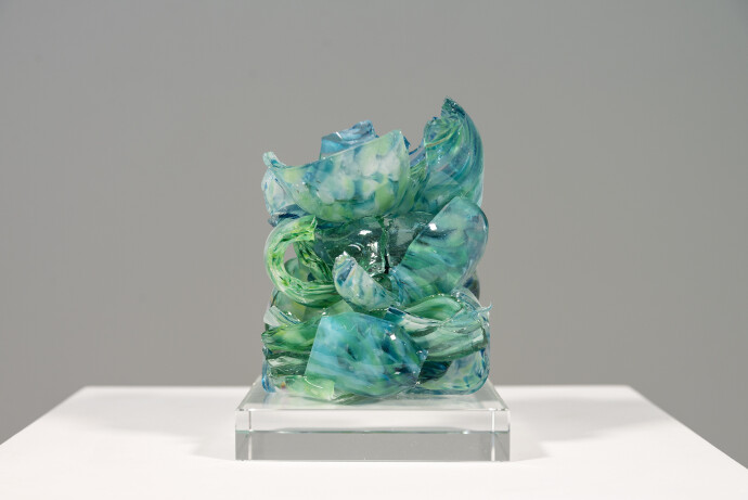 This contemporary turquoise glass sculpture is designed as a tabletop piece.
