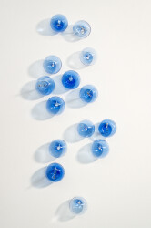 This contemporary cerulean colored glass wall sculpture was created by Cheryl Wilson Smith.