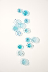 This contemporary wall sculpture features bubbles of blue glass.