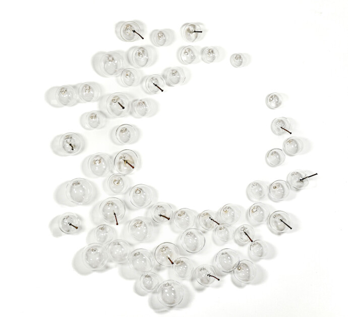 This contemporary glass wall sculpture features clear bubbles.
