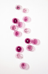 This contemporary wall sculpture features bubbles of pink glass.