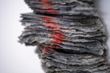 This contemporary glass wall sculpture resembles rock. Image 9