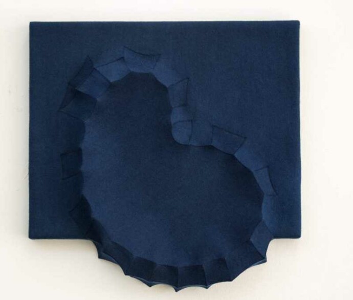 Sapphire blue felt takes the shape of a biomorphic form in this contemplative wall sculpture by fabric artist Chung-Im Kim.