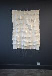 In this elegant monochromatic white tapestry by fabric artist Chung-Im Kim, finely detailed patterns swirl around the fabric. Image 3