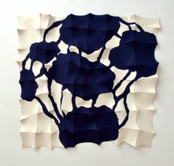 This contemporary, indigo-coloured sculptural textile wall hanging is handmade.