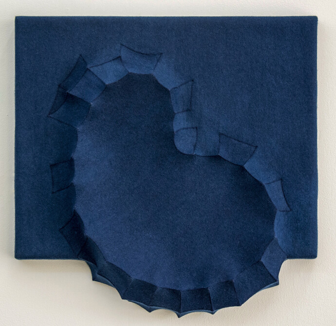 Sapphire blue felt takes the shape of a biomorphic form in this contemplative wall sculpture by fabric artist Chung-Im Kim.
