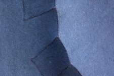 Sapphire blue felt takes the shape of a biomorphic form in this contemplative wall sculpture by fabric artist Chung-Im Kim. Image 5