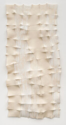 This contemporary white sculptural wall hanging was handmade.