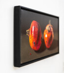 Two red-orange pomegranates, one cut cleanly in half are set on a dark ground in this realistically rendered and intimate oil painting on ca… Image 3