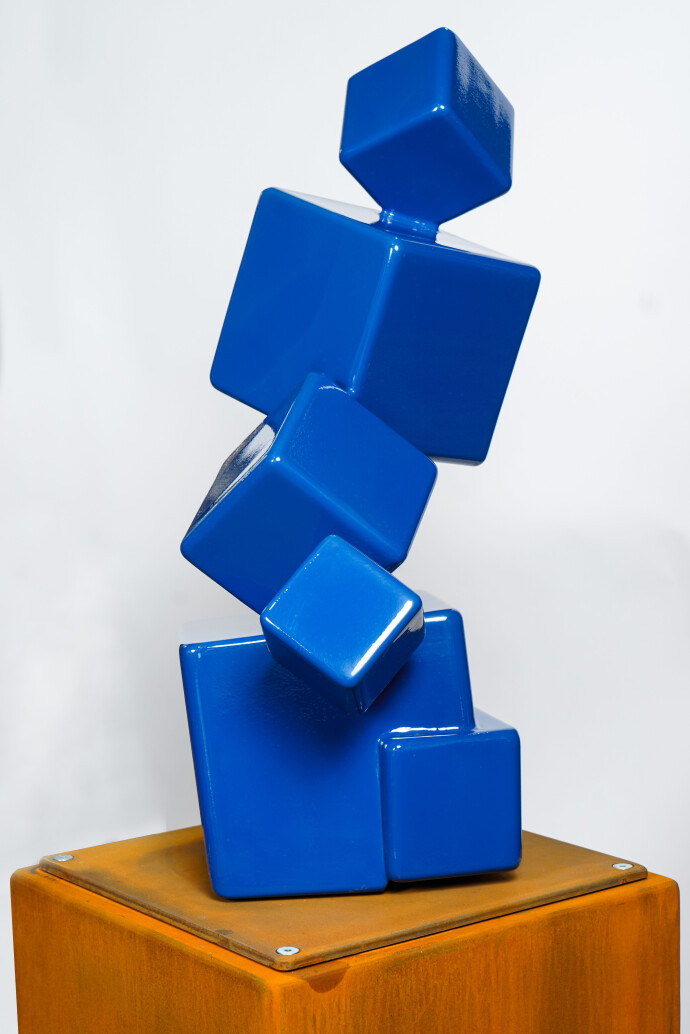 This contemporary indoor abstract sculpture has a geometric form made from steel.