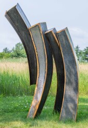 This striking blackened corten steel sculpture was created by Claude Millette.