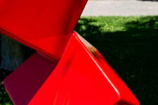 This outdoor contemporary geometric metal sculpture is made of red cubes. Image 4