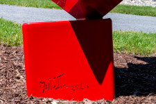 This outdoor contemporary geometric metal sculpture is made of red cubes. Image 5