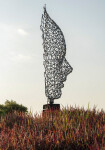 A human face emerges from the intricately designed stainless steel mesh of this intriguing sculpture. Image 7