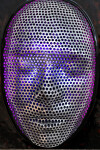 This contemporary figurative wall sculpture is a mask forged from metal lit with LED light. Image 7