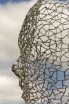 A human face emerges from the intricately designed stainless steel mesh of this intriguing sculpture. Image 3