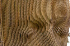 A mask of steel aircraft cable is framed by a halo of unwound ends. Image 7