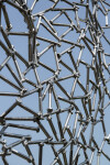 A human face emerges from the intricately designed stainless steel mesh of this intriguing sculpture. Image 4