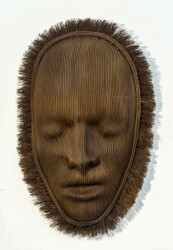 A mask of steel aircraft cable is framed by a halo of unwound ends.