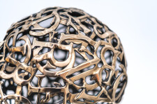 This contemporary table top sculpture is a mask forged from metal. Image 8