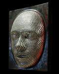 This contemporary figurative wall sculpture is a mask forged from metal lit with LED light. Image 3