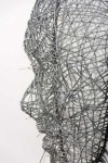 Strands of steel aircraft cable are woven into a silent, glittering mask by sculptor Dale Dunning. Image 3
