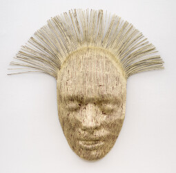 This contemporary sculpture is a mask forged from air craft cable and then carefully gilded with gold leaf.