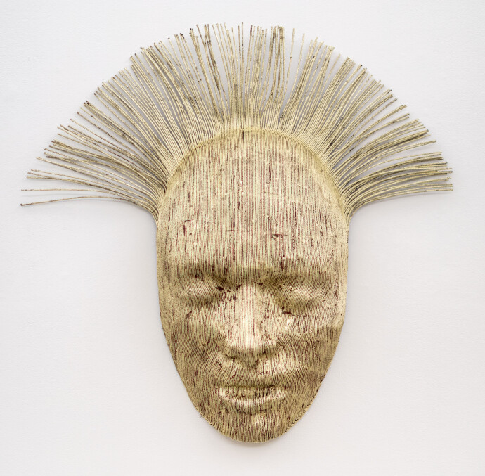 This contemporary sculpture is a mask forged from air craft cable and then carefully gilded with gold leaf.