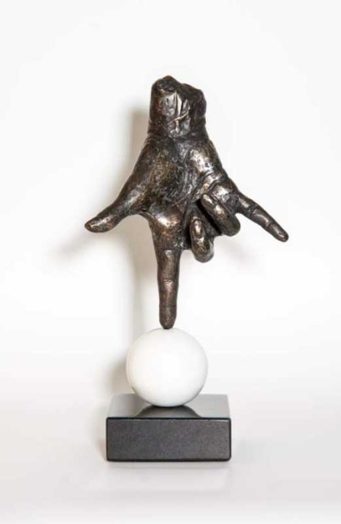 A bronze hand, modelled after the artist’s own, balances on its index finger atop a sphere in this imaginative pop art sculpture by Dave She…