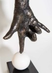 A bronze hand, modelled after the artist’s own, balances on its index finger atop a sphere in this imaginative pop art sculpture by Dave She… Image 3