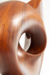 The graceful curves of this contemporary solid mahogany sculpture by David Chamberlain appear to emulate the image of a heart. Image 3