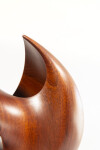 The graceful curves of this contemporary solid mahogany sculpture by David Chamberlain appear to emulate the image of a heart. Image 4