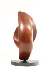 The graceful curves of this contemporary solid mahogany sculpture by David Chamberlain appear to emulate the image of a heart. Image 12