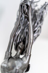 This contemporary figurative indoor sculpture of a female is hand forged from metal. Image 9