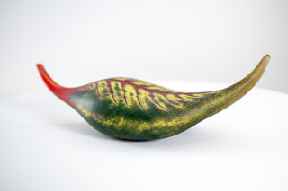 Australian glass artist Eileen Gordon’s leaf in jewel tones of red and forest green captures the lovely organic shape of a fallen leaf.