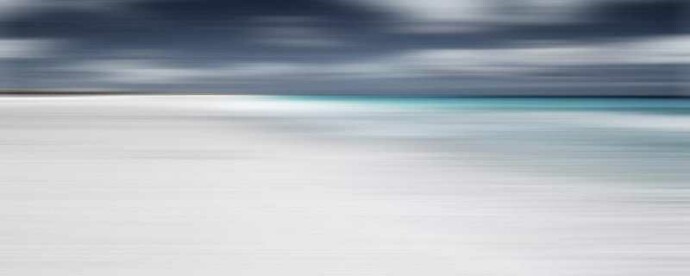 In this serene composition by Etienne Labbé, the bright white sand of a beach meets the shining aqua sea and a dramatic cloudy sky.