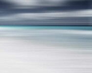 In this serene composition by Etienne Labbé, the bright white sand of a beach meets the shining aqua sea and a dramatic cloudy sky. Image 3