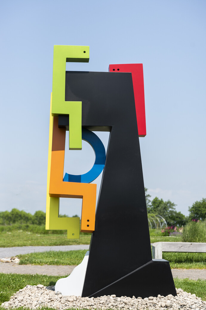 This contemporary abstract outdoor steel sculpture represents a male figure.