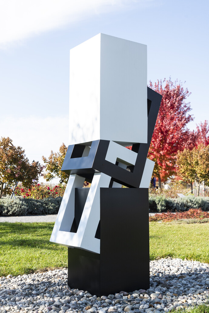 This abstract sculpture, which can be installed indoors or outdoors, is painted in a striking black and white.